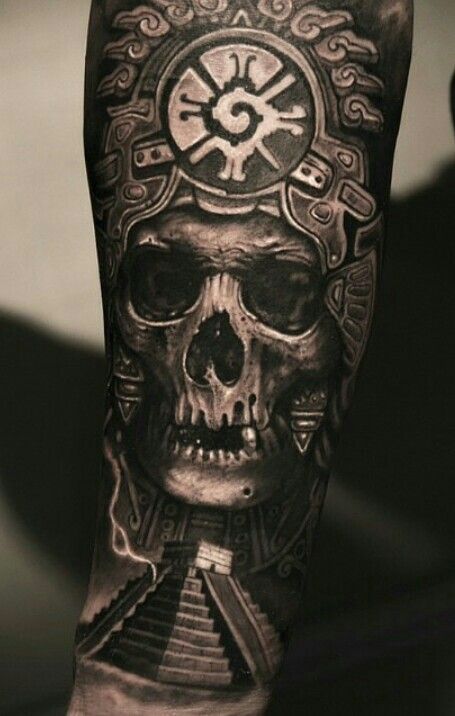 Skull in a solar headdress, Hunab Ku on the brow, a pyramid at the jaw
